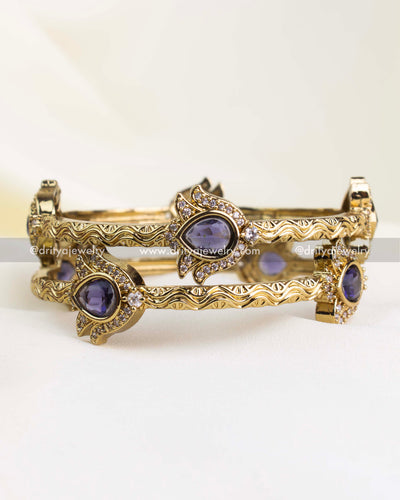 Antique gold finish kada with purple pear-cut stones and CZ border detailing.