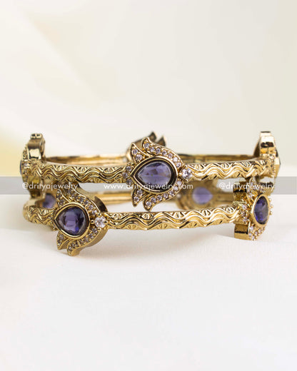 Antique gold finish kada with purple pear-cut stones and CZ border detailing.