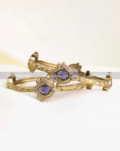 Antique gold finish kada with purple pear-cut stones and CZ border detailing.