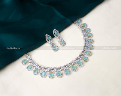 Elegant zircon short necklace set with aqua blue teardrop stones and AD embellishments, paired with matching drop earrings.