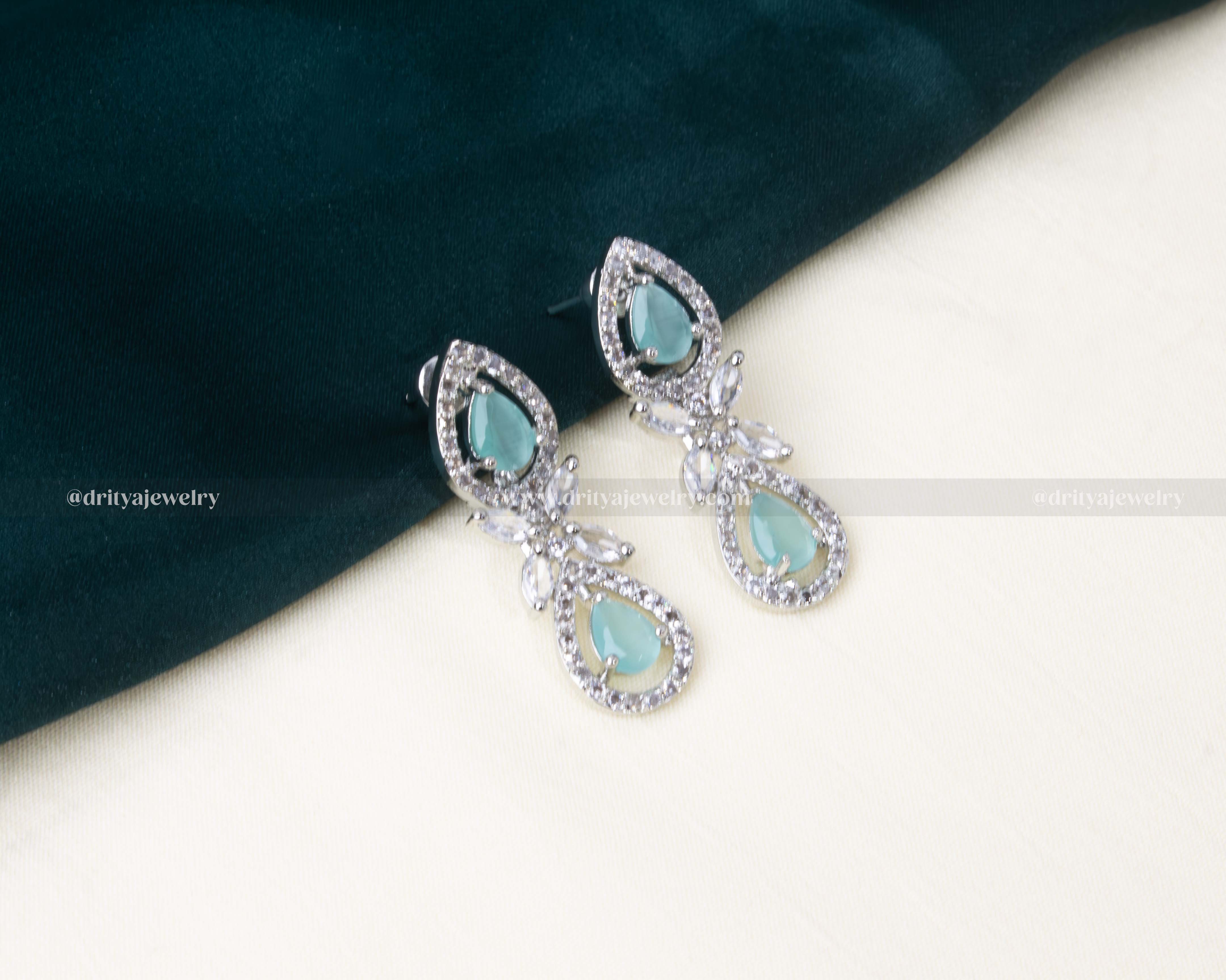 Elegant zircon short necklace set with aqua blue teardrop stones and AD embellishments, paired with matching drop earrings.