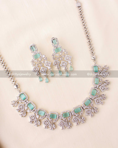 Short necklace with aqua blue stones and zircon detailing in a rhodium finish.
