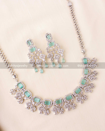 Short necklace with aqua blue stones and zircon detailing in a rhodium finish.