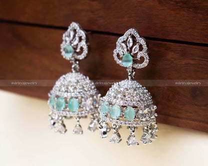 Aqua blue zircon Jhumka set with shimmering AD stones and delicate danglers.