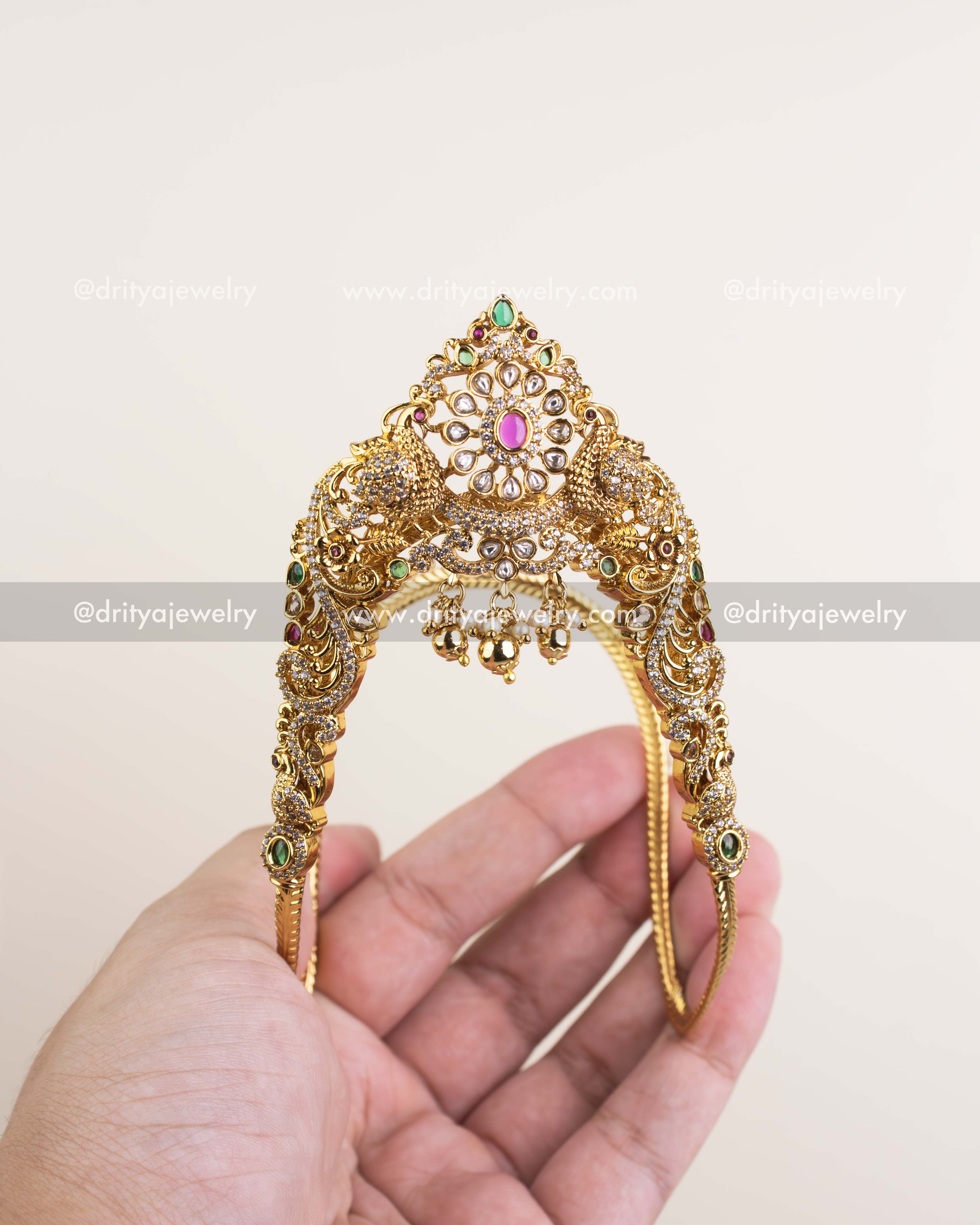Elegant Ara Vanki armlet featuring polki centerpiece, ruby-emerald accents, and CZ embellishments.
