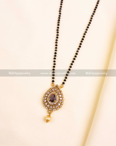 Purple teardrop pendant on black bead chain with pearl drop and crystal halo.