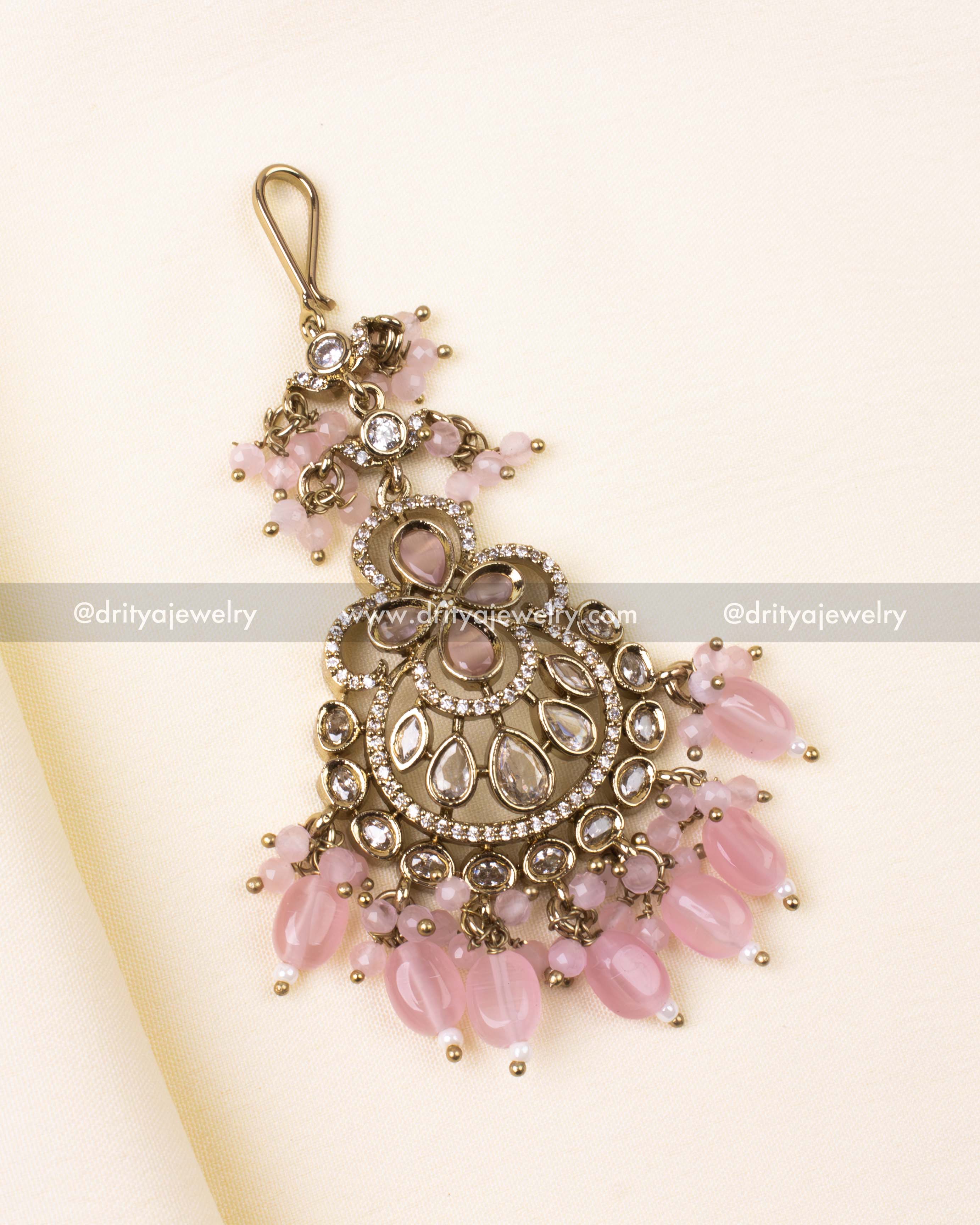 Victorian-style tikka in blush pink with teardrop stones and delicate bead hangings.