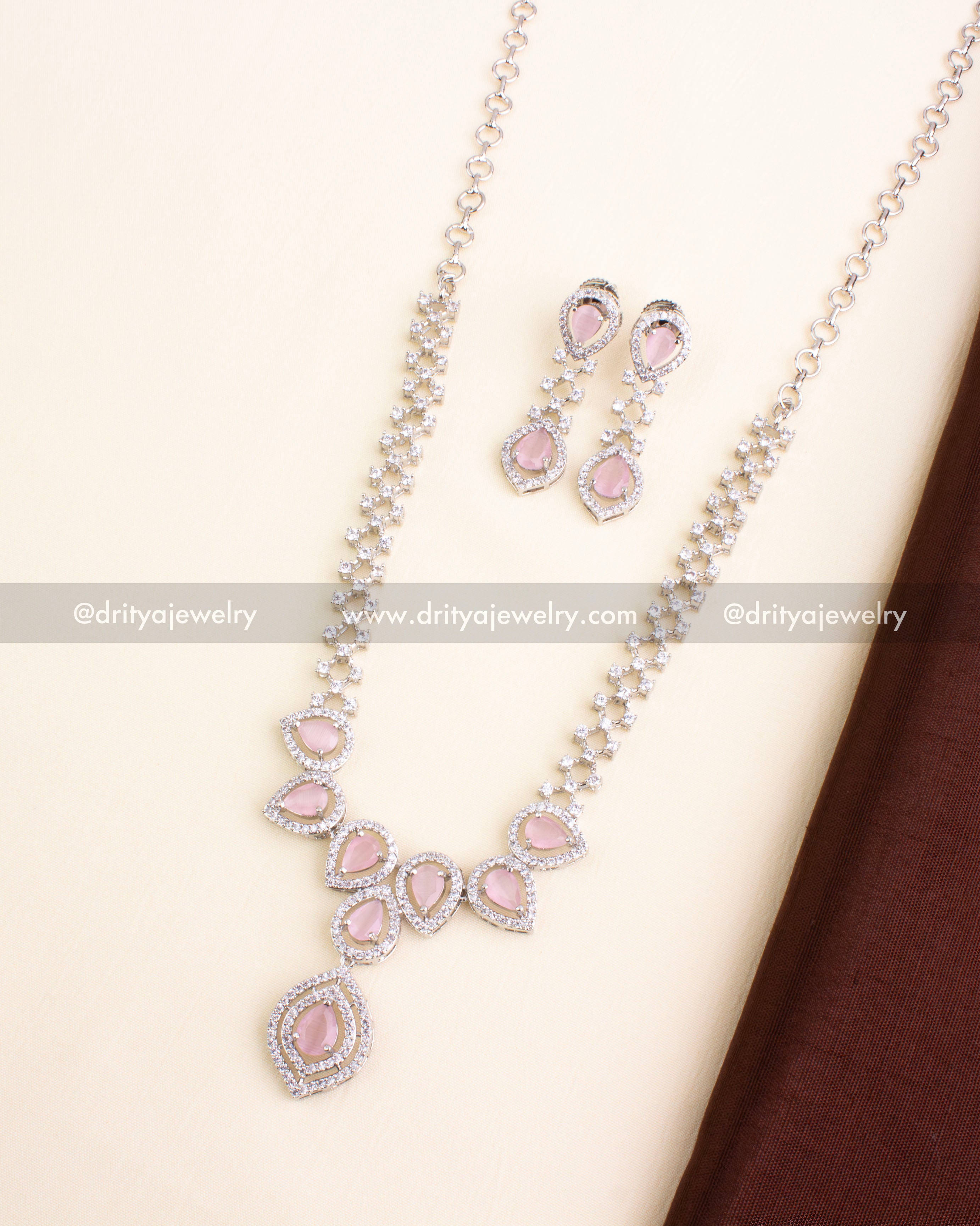 Zircon necklace set featuring blush pink stones and AD work with matching earrings