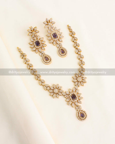 Purple and gold floral necklace set with cubic zirconia and drop detailing.