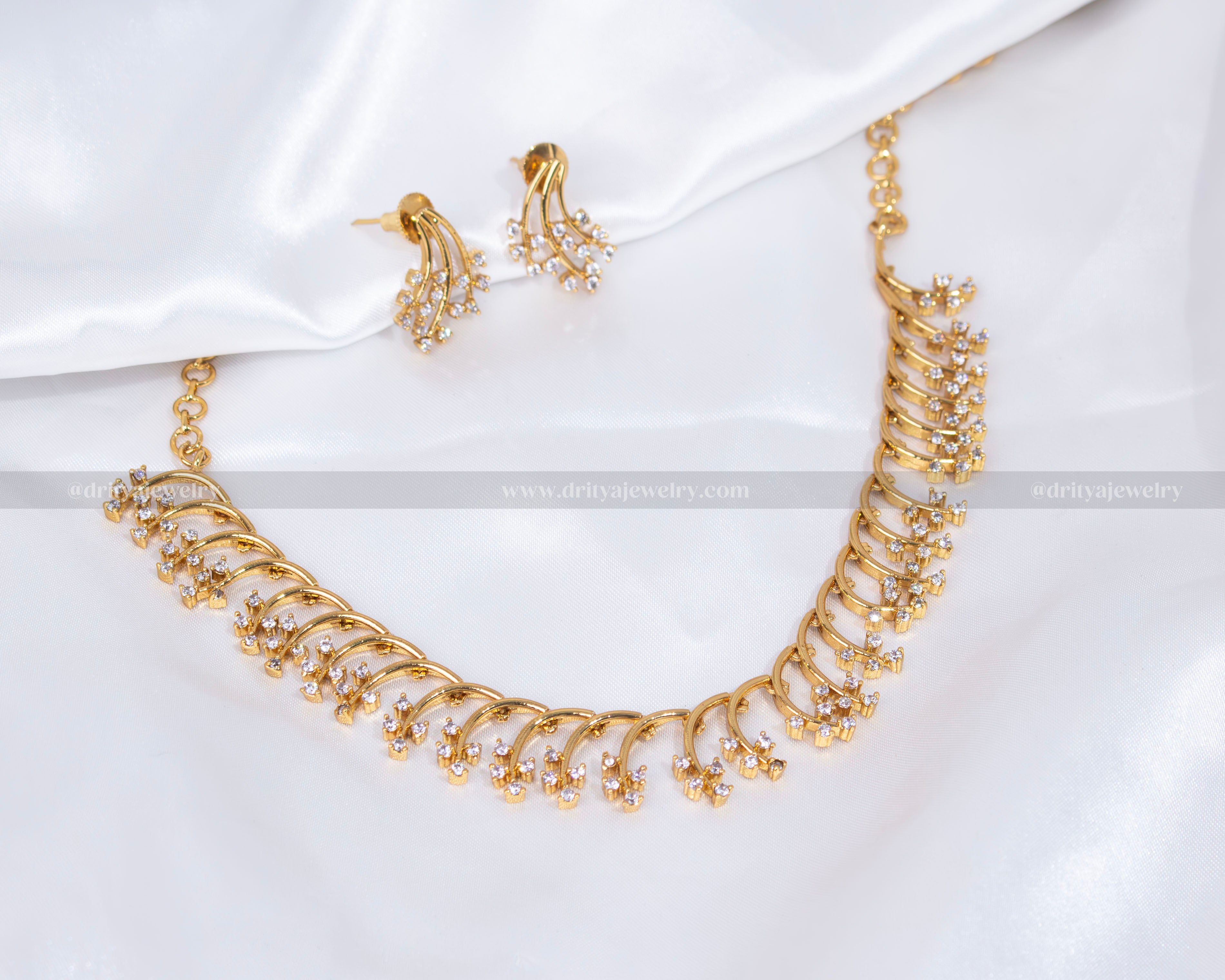 Elegant CZ Necklace Set in white stones with matching earrings, displayed on a white backdrop.