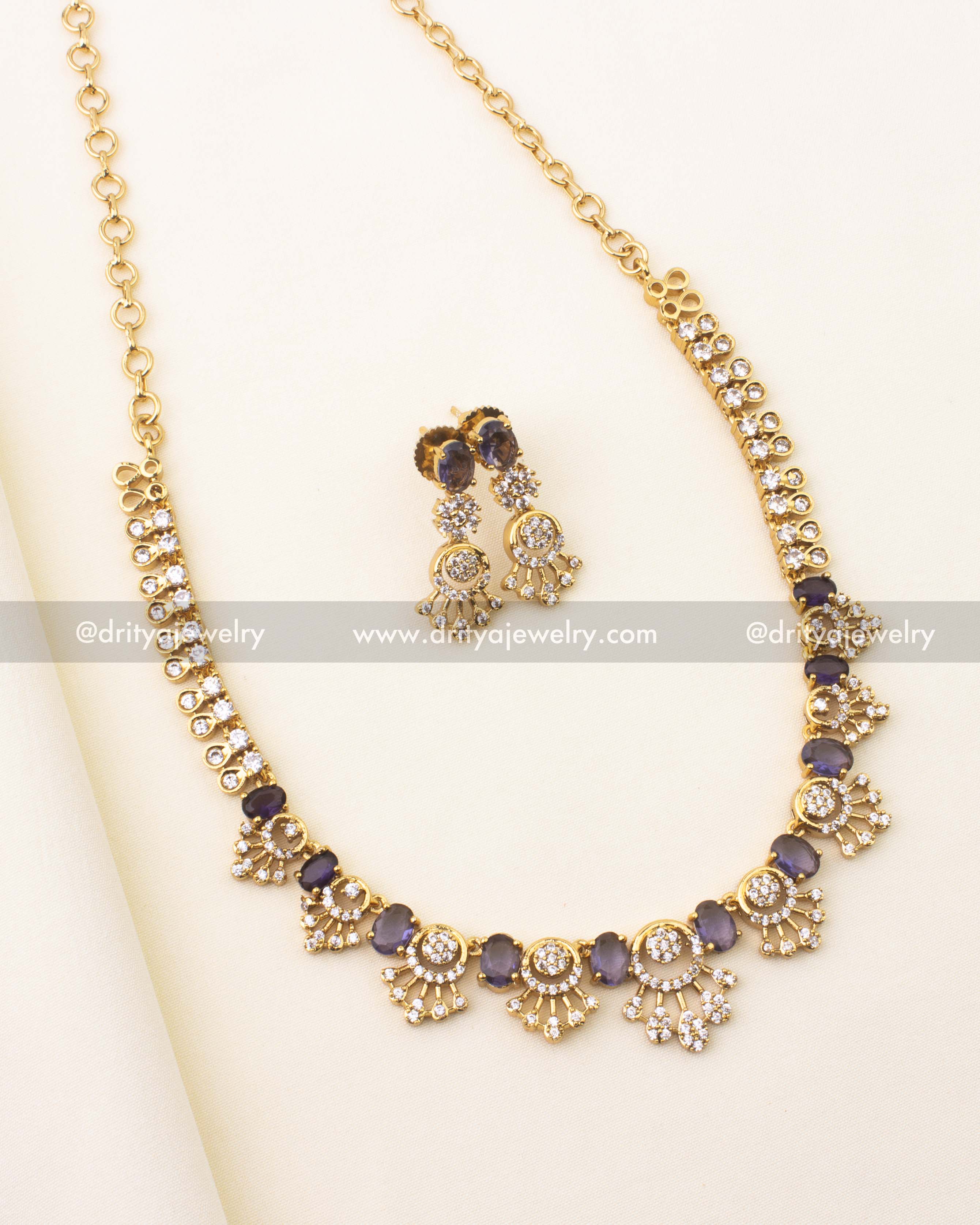 Elegant short necklace with oval purple stones and CZ embellishments.