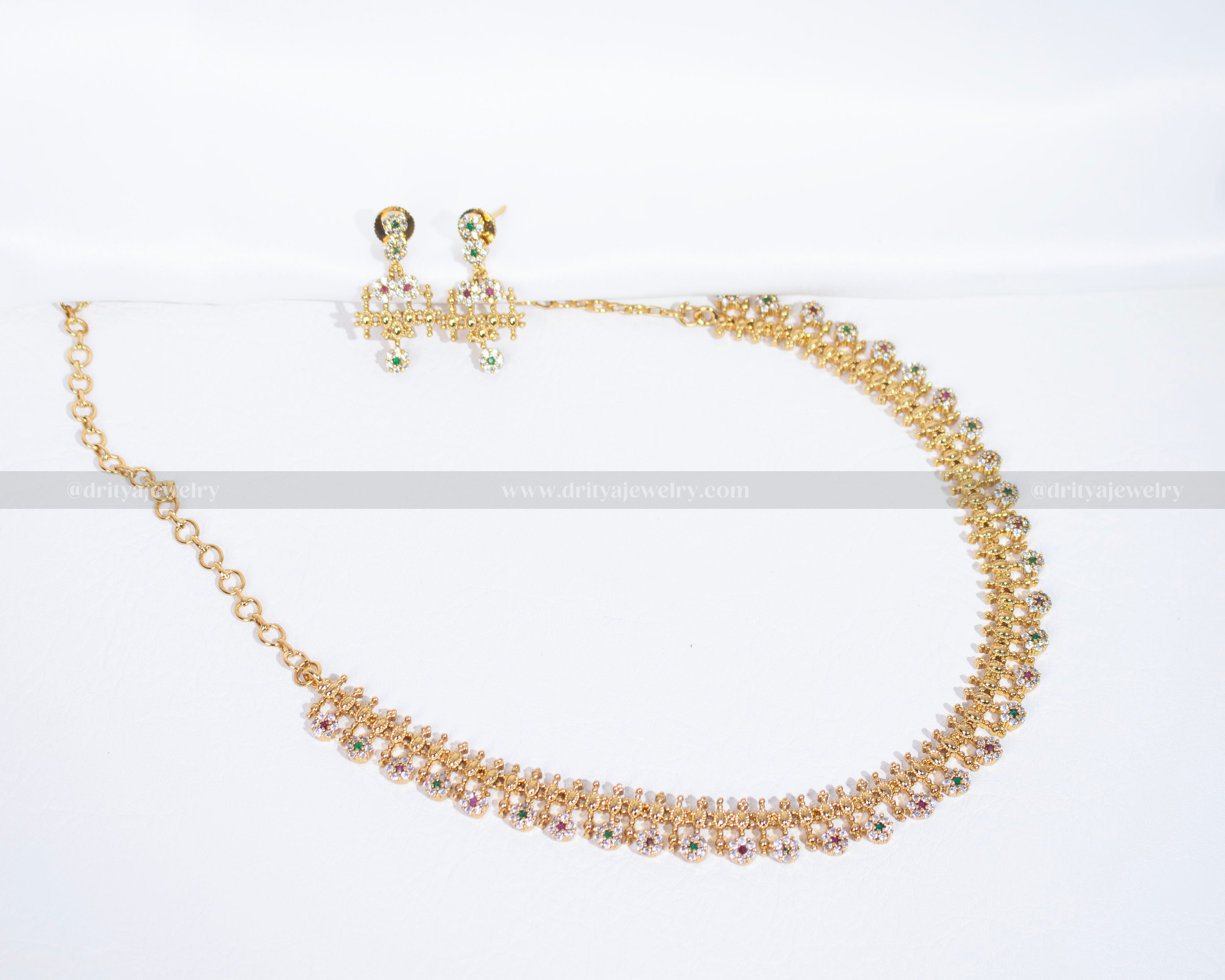 Front view of Dritya Jewelry’s necklace set featuring pink and green stones mixed with Cubic Zirconia stones, adding a touch of playful elegance.