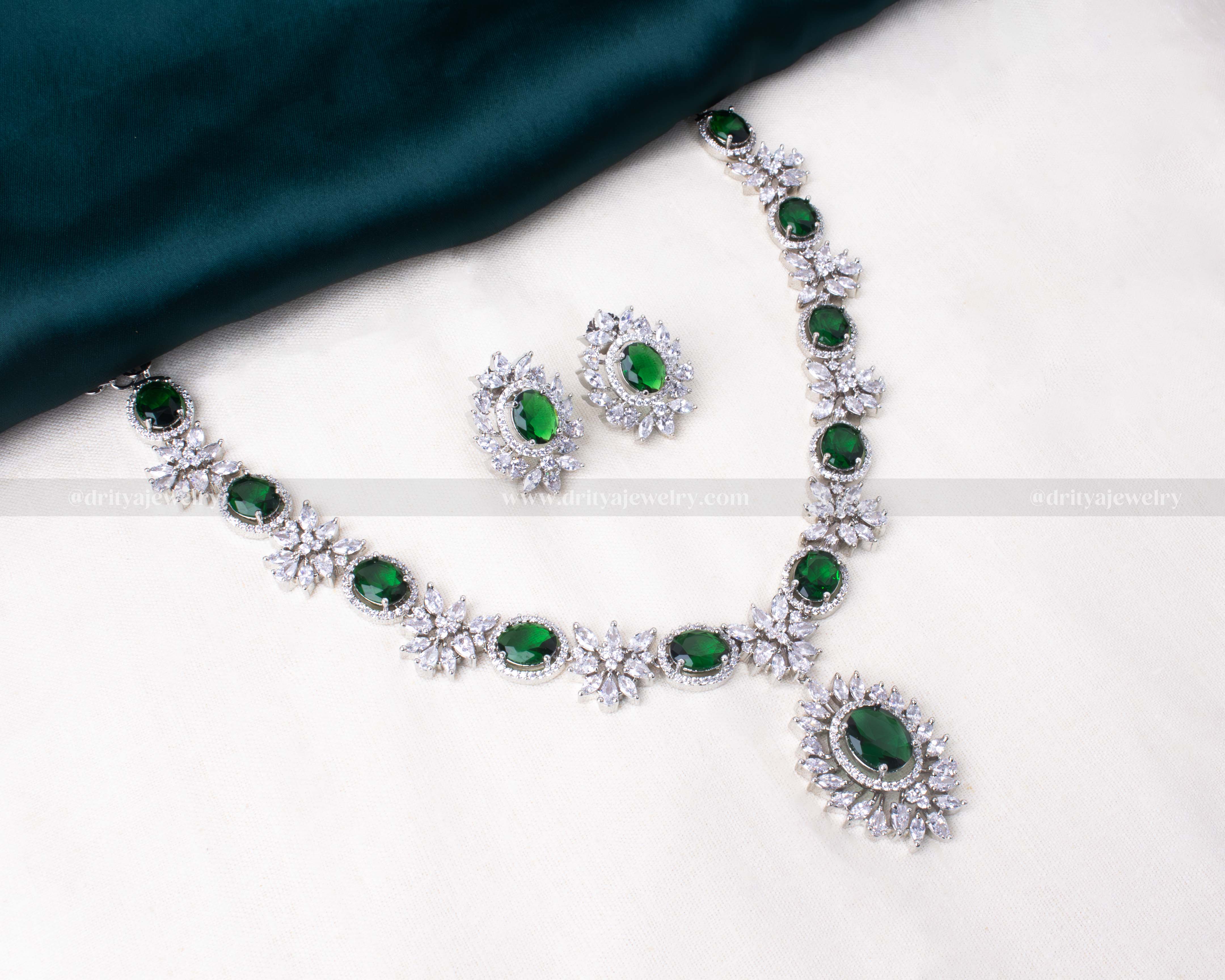 Elegant silver-tone necklace set with green zircon centers surrounded by sparkling clear CZ, perfect for special occasions.