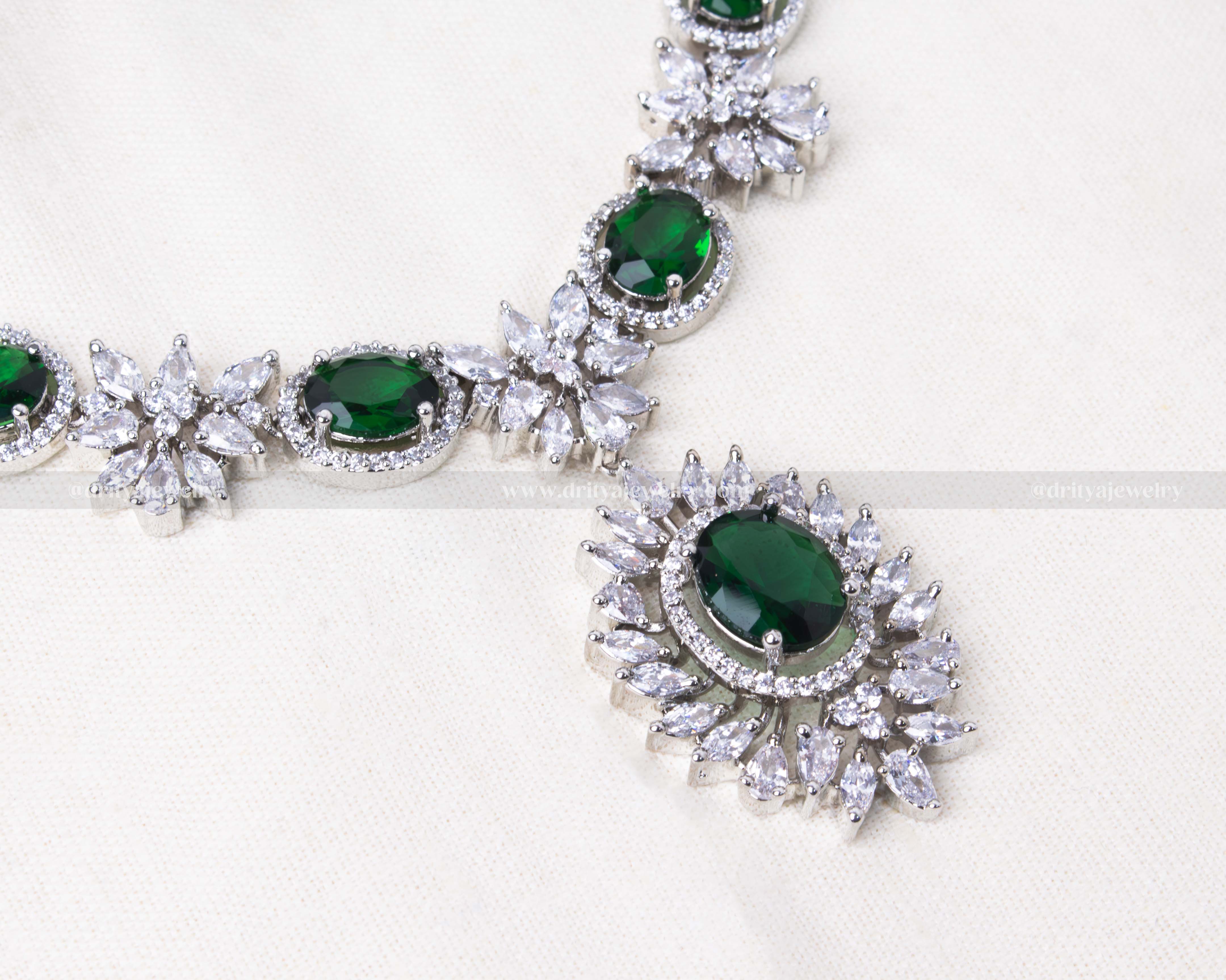 Elegant silver-tone necklace set with green zircon centers surrounded by sparkling clear CZ, perfect for special occasions.