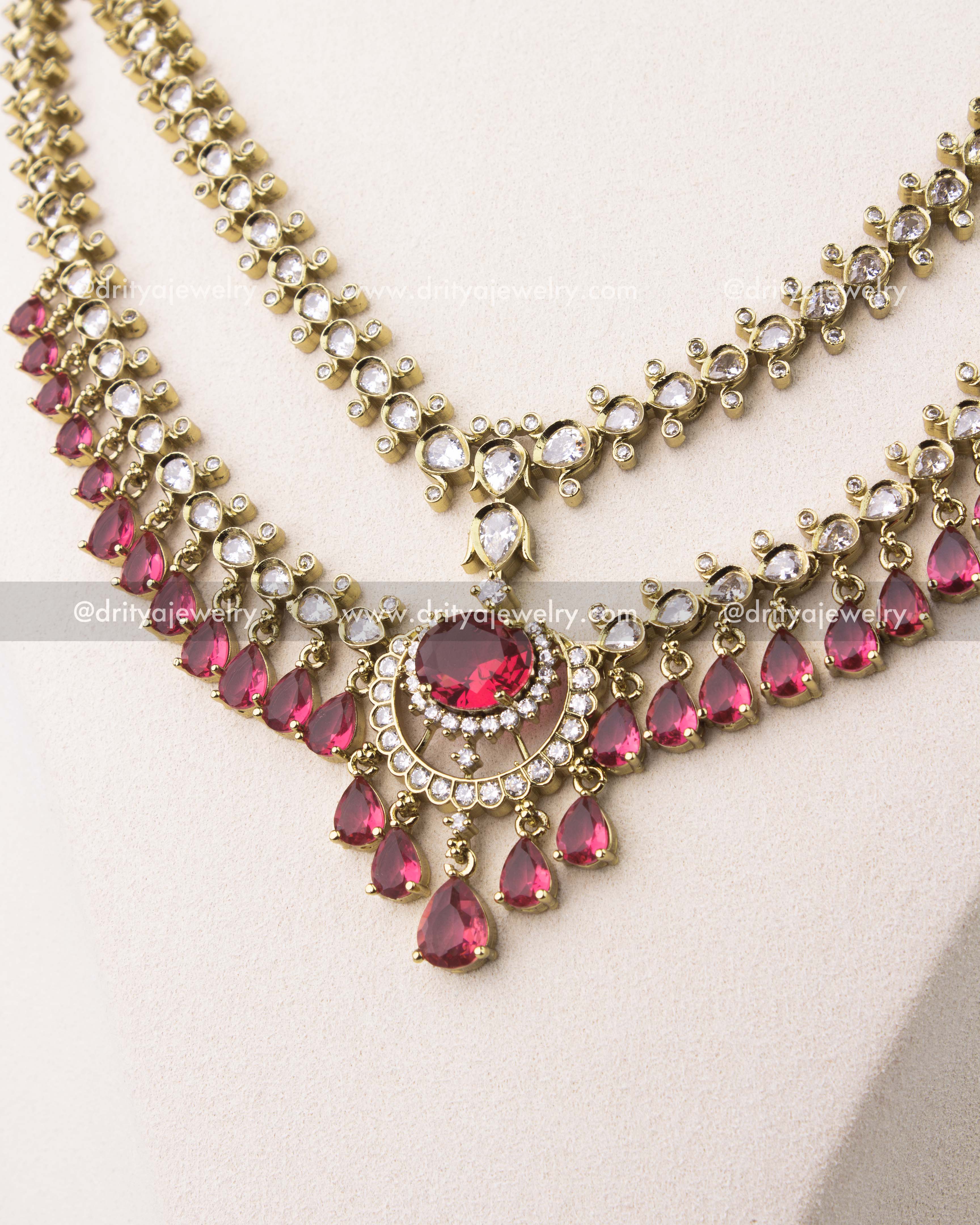 close up of Victorian layered short necklace set with ruby red stones and gold finish
