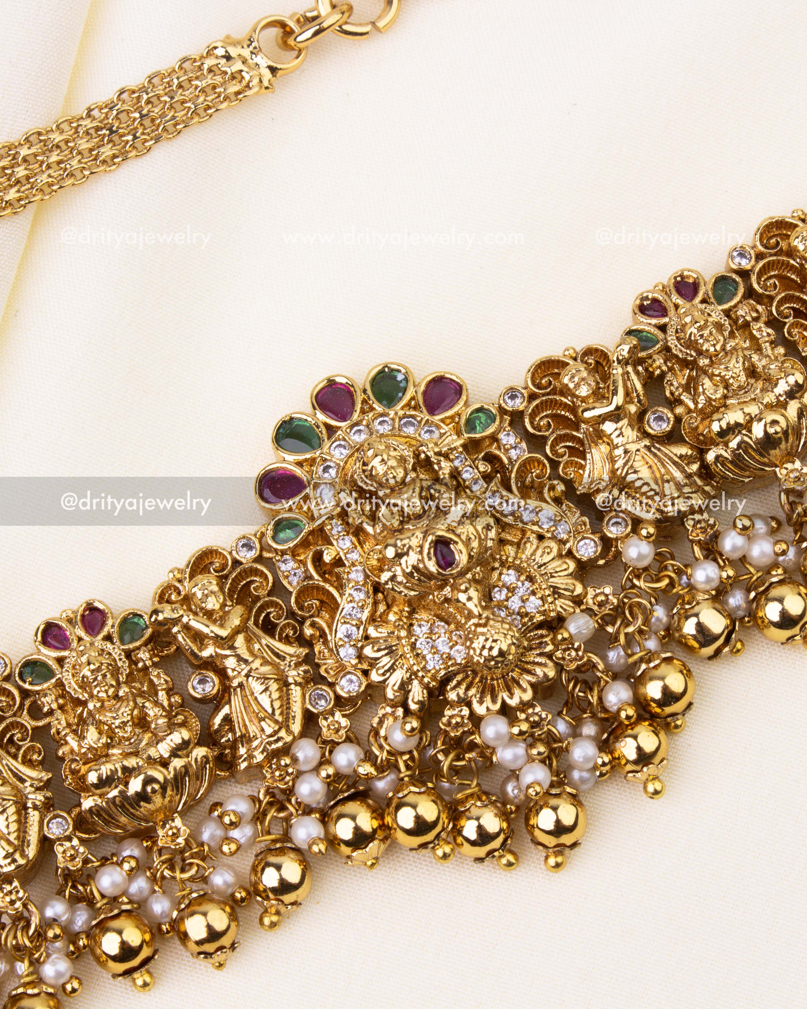 Central goddess motif with peacock design and pearl clusters in temple jewelry style.