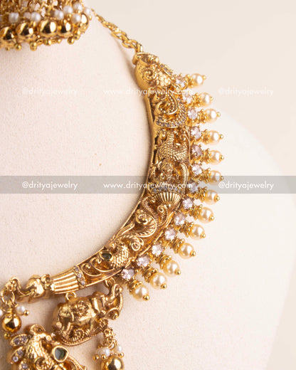 Handcrafted temple chain with elephant and floral Nakshi carvings in antique finish.