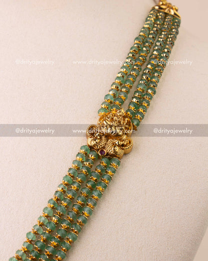 Multi-strand green beads with antique Nakshi detailing.