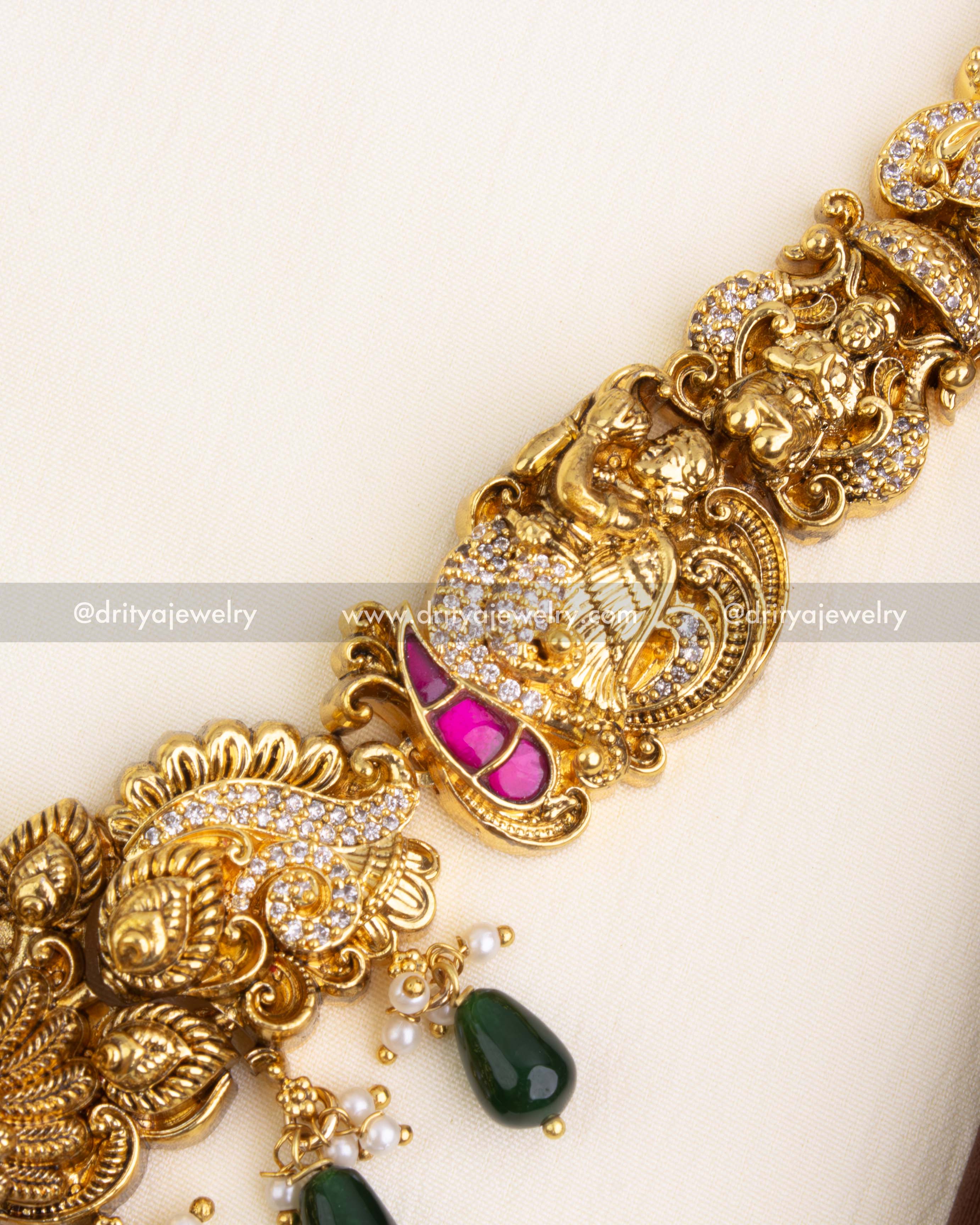 Intricately designed chain with peacock, goddess, and floral Nakshi carvings.