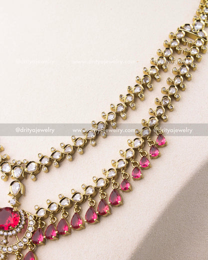 close up of Victorian layered short necklace set with ruby red stones and gold finish