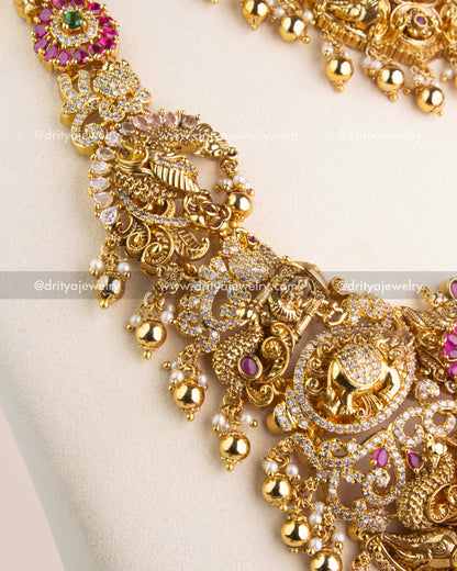 Antique gold Nakshi chain featuring intricate carvings and ruby red kemp stones.