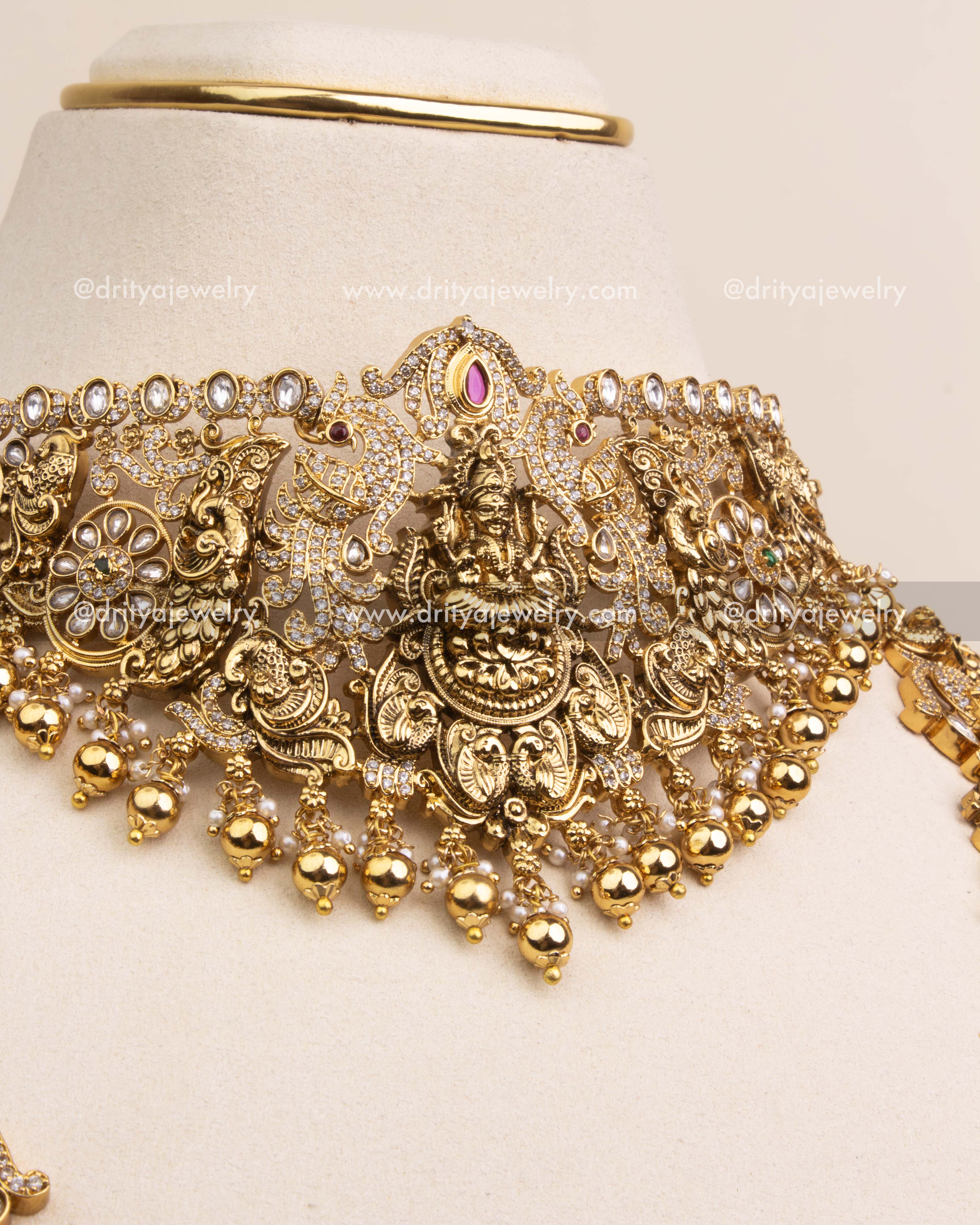 emple-style choker featuring goddess Lakshmi and intricate Kundan peacocks