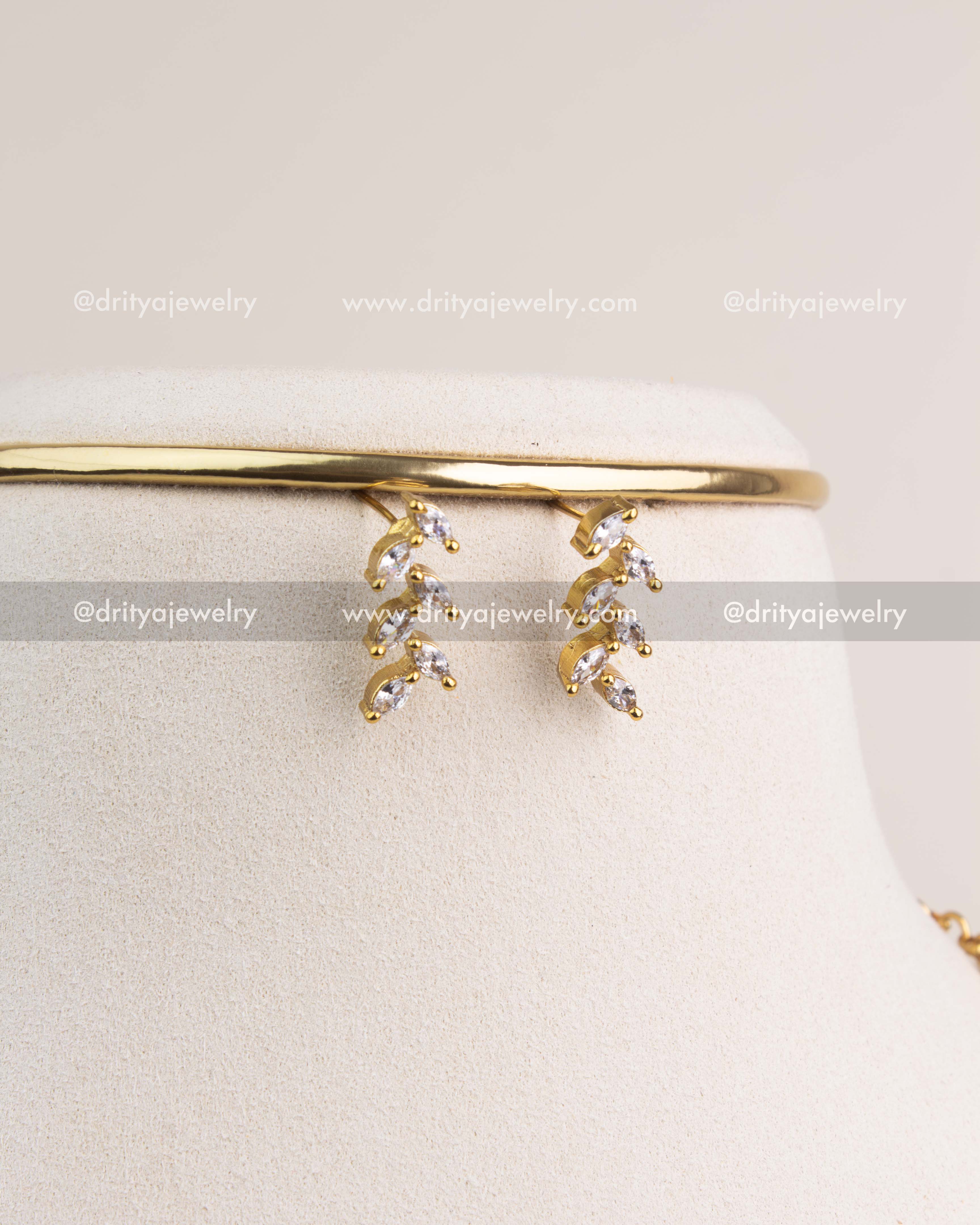 Matching CZ climber earrings with gold finish and diamond-style sparkle.