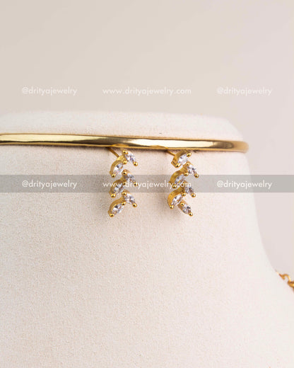 Matching CZ climber earrings with gold finish and diamond-style sparkle.