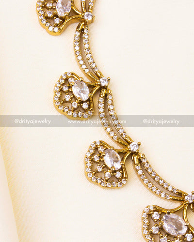 Fan-shaped pendants with centered oval CZ stones and Victorian goldwork.