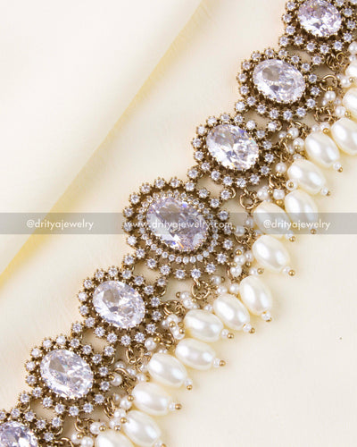 White center stones with halo setting and pearl fringe