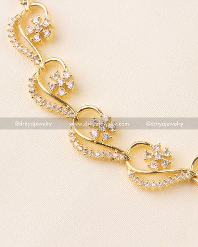 Detailed close-up of delicate CZ-studded floral clusters in gold-plated necklace