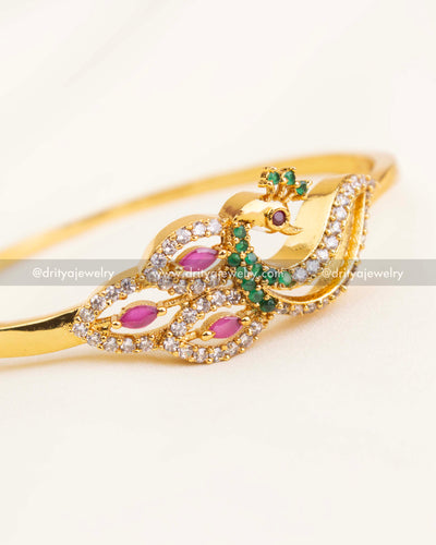 Detailed view of peacock kada with marquise pink stones, green accents, and American Diamonds
