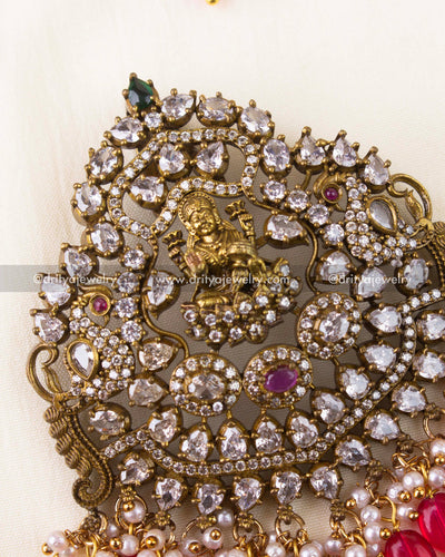 Detailed close-up of antique gold Victorian pendant with Lakshmi motif and intricate stonework