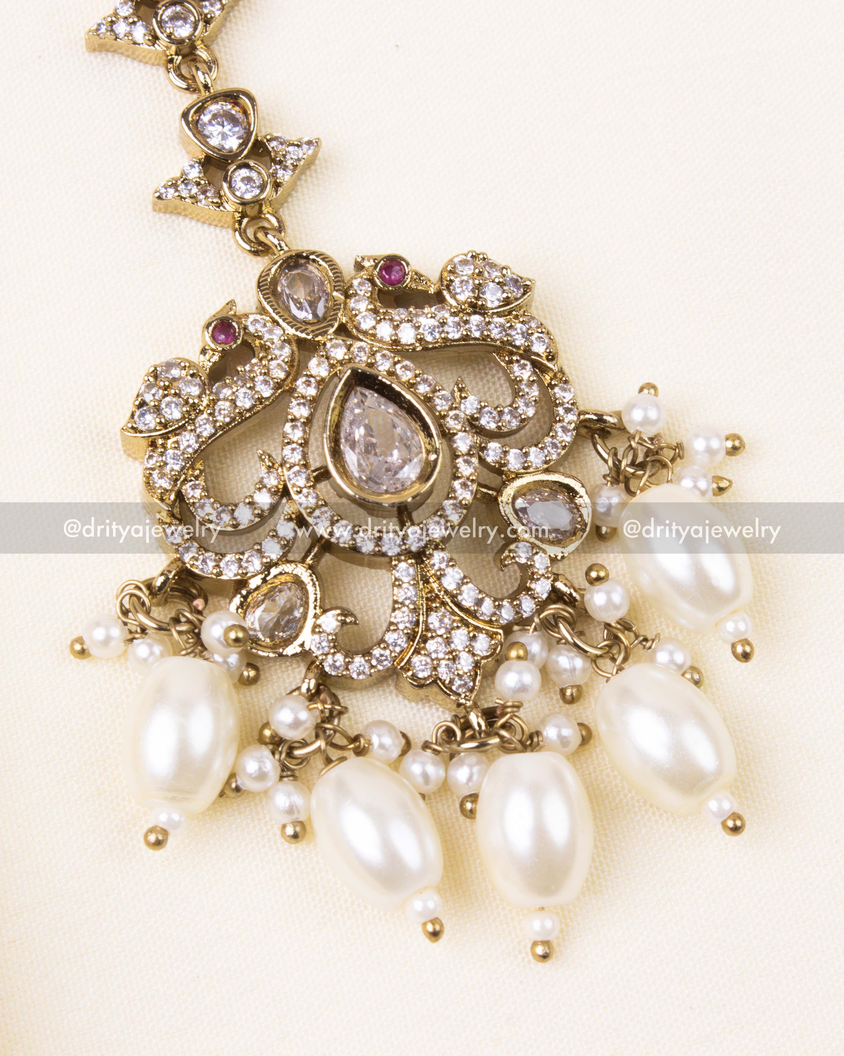 Detailed design of white AD-studded Victorian tikka with classic pearl beads.