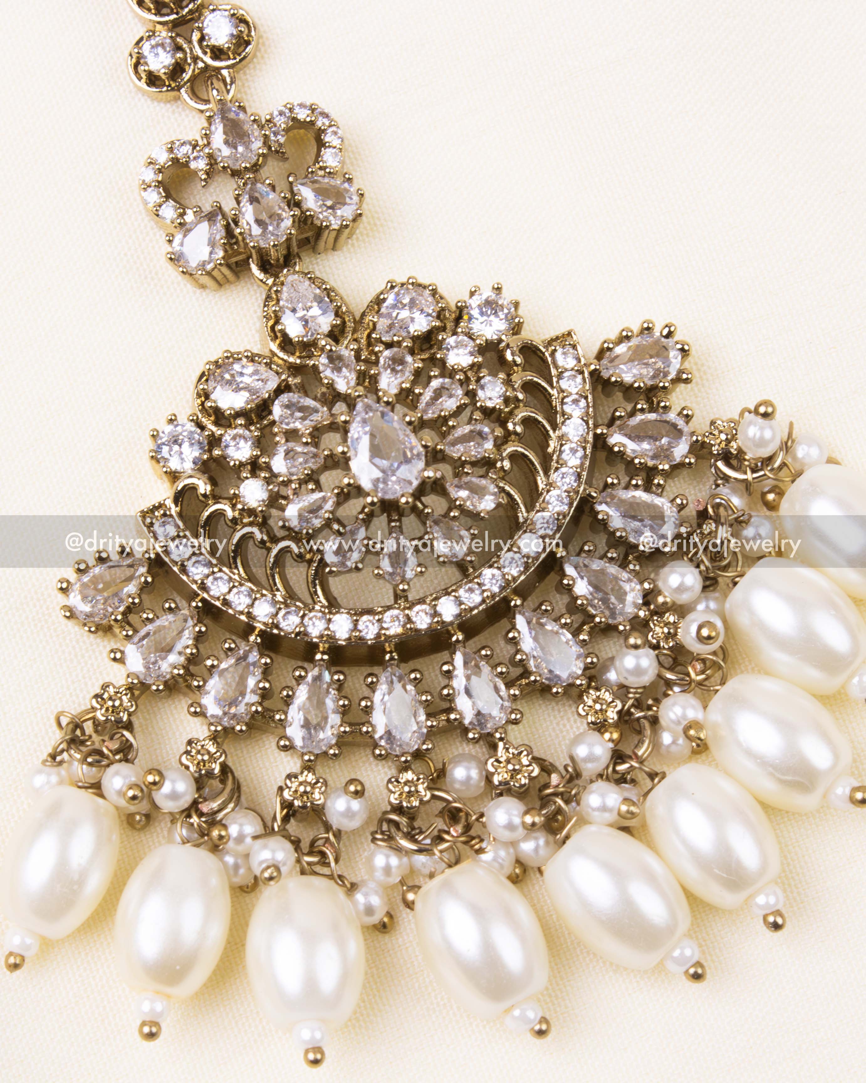 Detailed design of white AD-studded Victorian tikka with classic pearl beads.