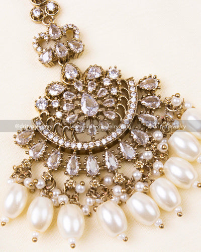 Detailed design of white AD-studded Victorian tikka with classic pearl beads.