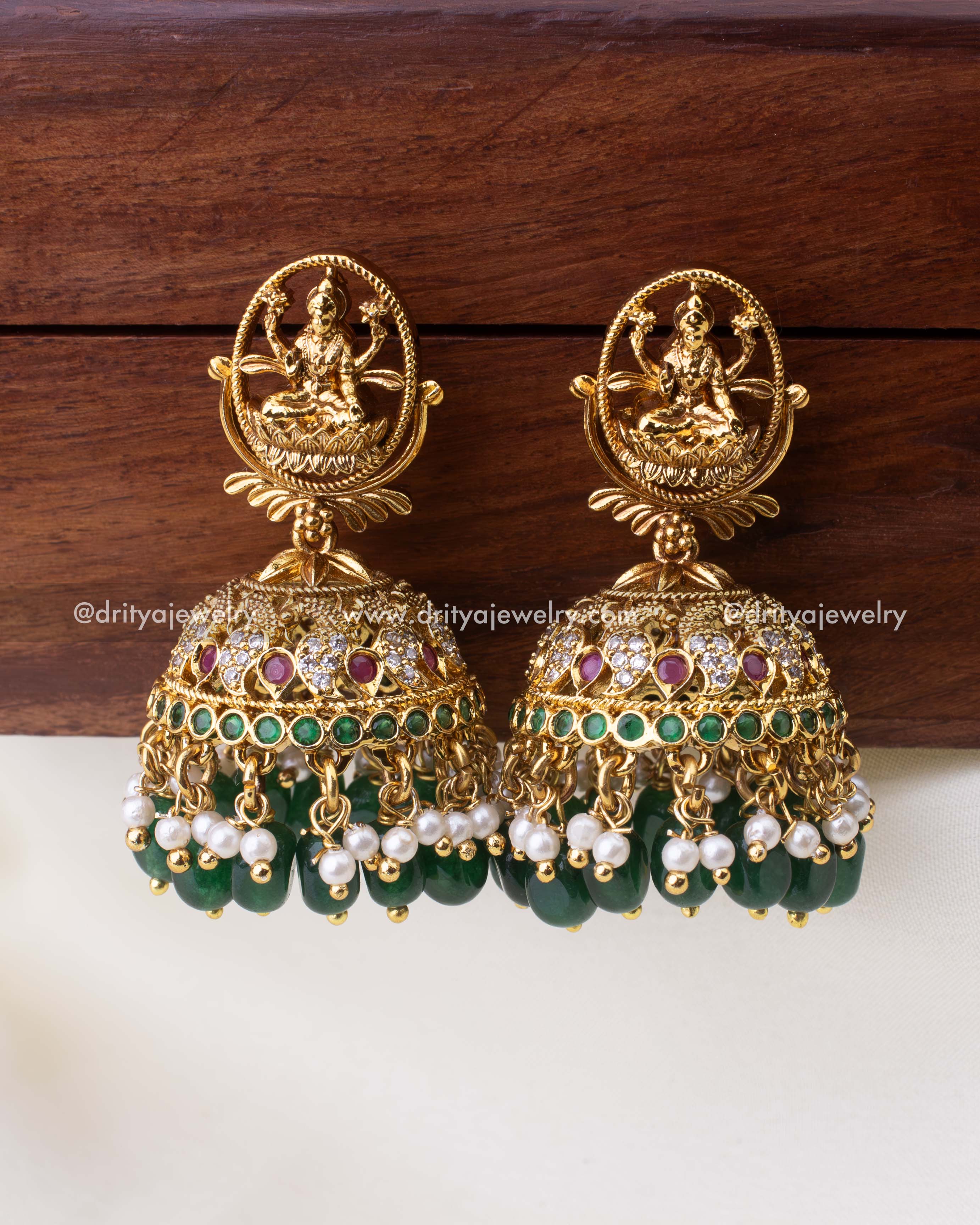 Antique temple-style Jhumkas with Goddess Lakshmi stud, ruby and emerald stones, and nakshi detailing.