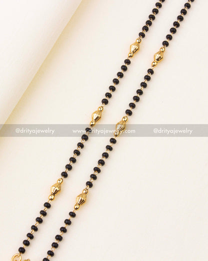 Intricate Venkateswara Swamy deity pendant with antique gold finish and pearl danglers.