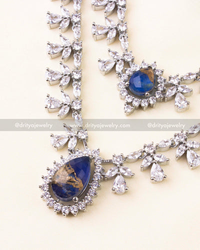 Royal blue teardrop pendant with surrounding CZ sparkle on layered necklace.