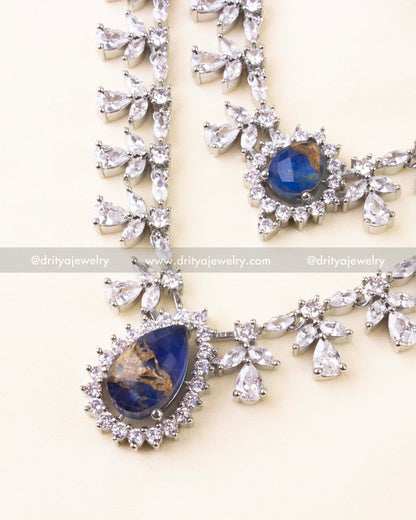 Royal blue teardrop pendant with surrounding CZ sparkle on layered necklace.