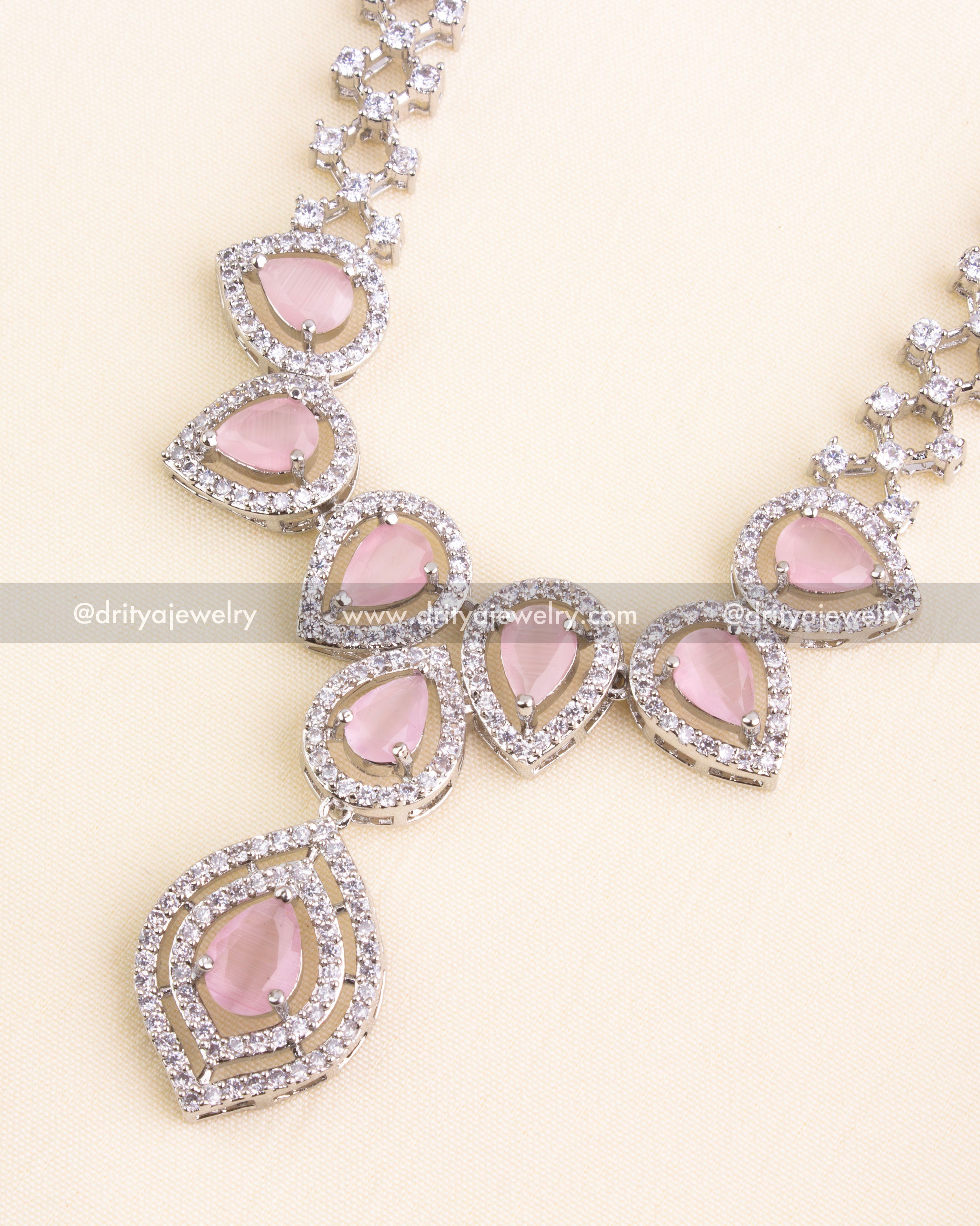 Teardrop blush pink stones set in AD halos on a rhodium-plated necklace