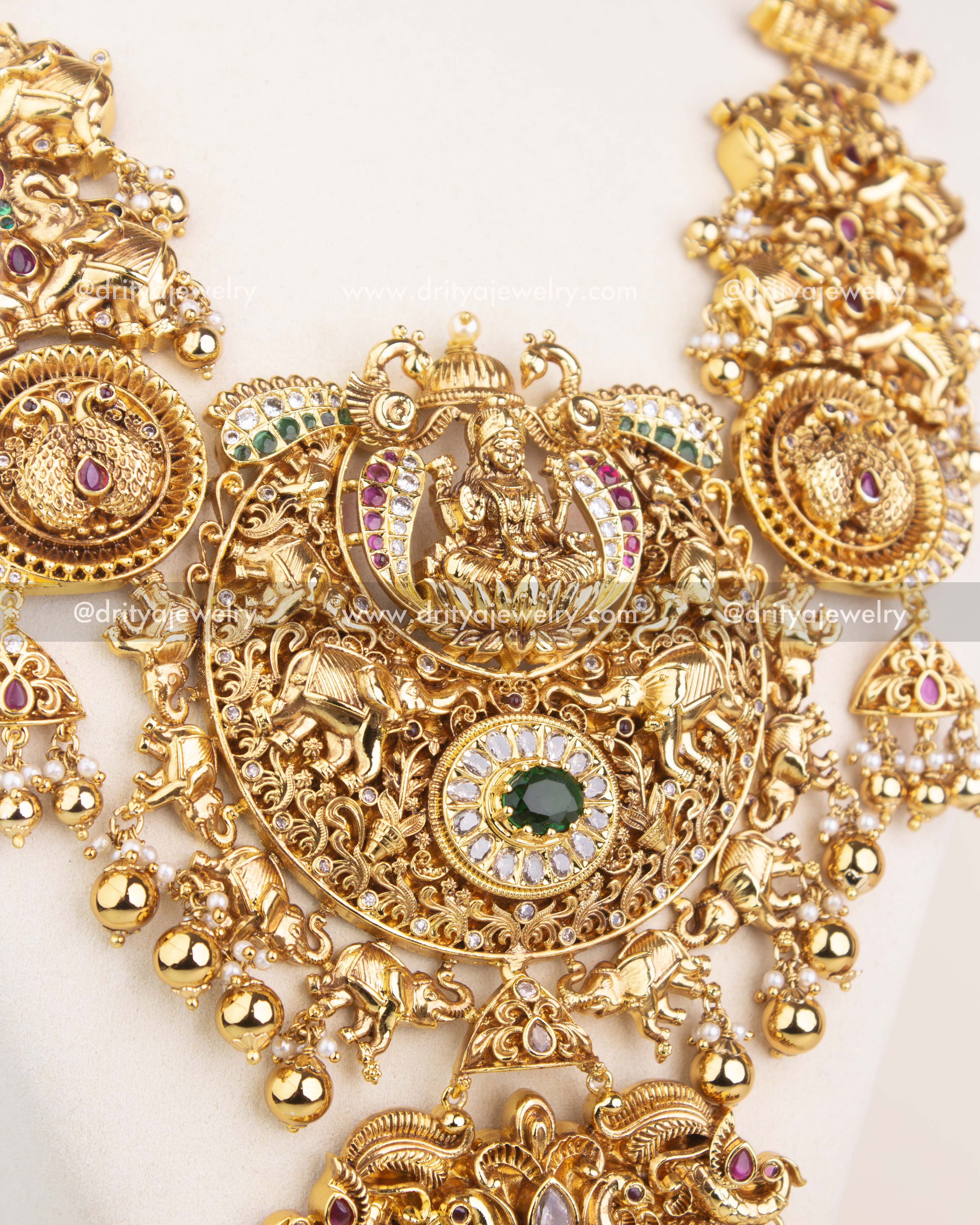 Detailed pendant design featuring Lakshmi, animal motifs, and CZ stone embellishments in antique polish.