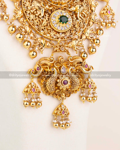 Detailed pendant design featuring Lakshmi, animal motifs, and CZ stone embellishments in antique polish.