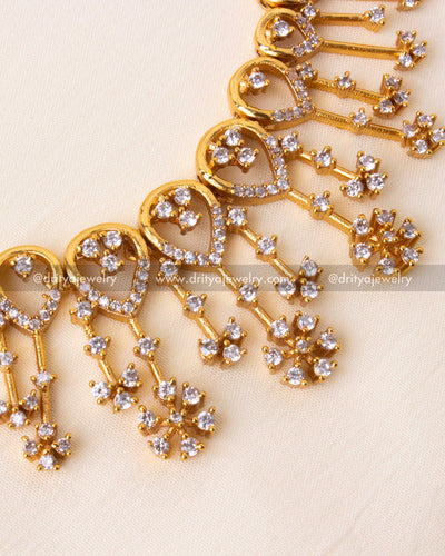 Detailed view of cubic zirconia floral dangles on short necklace