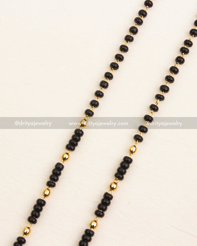 Premium single-line black beads necklace with antique temple pendant and pearl drops.