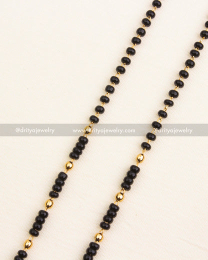 Premium single-line black beads necklace with antique temple pendant and pearl drops.