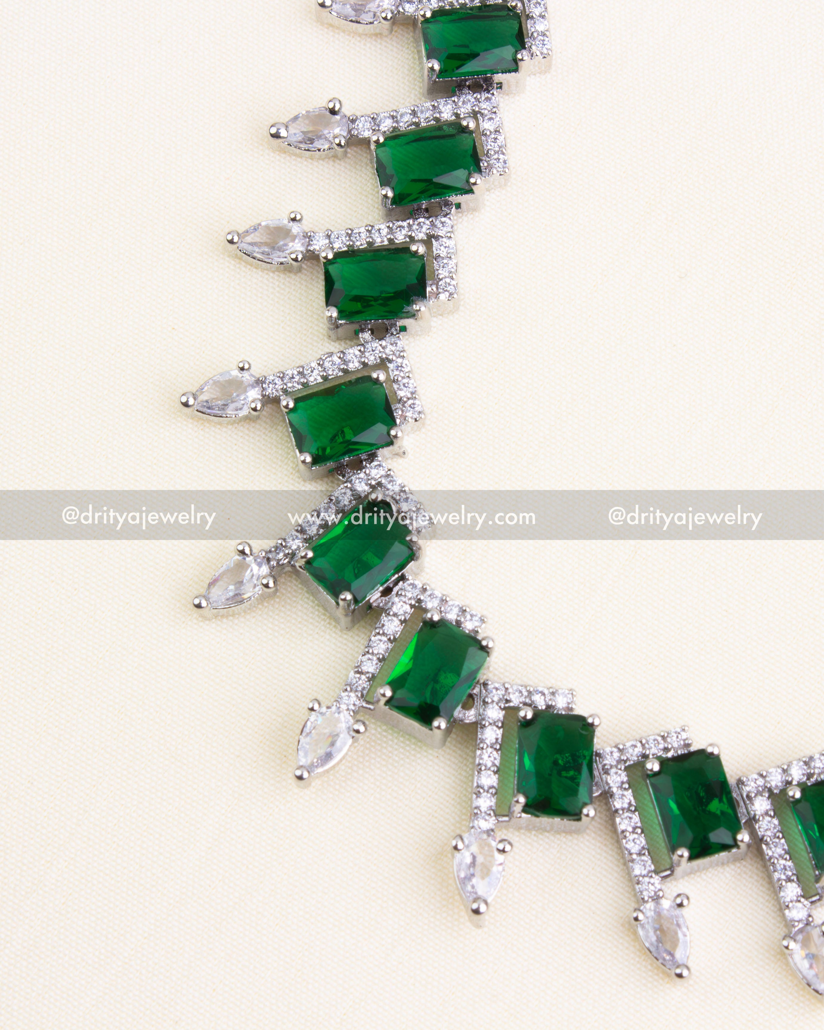 Detailed view of emerald cut stones with AD accents and teardrop CZs