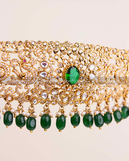 Detailed view of kundan waist belt with green bead hangings and intricate work.