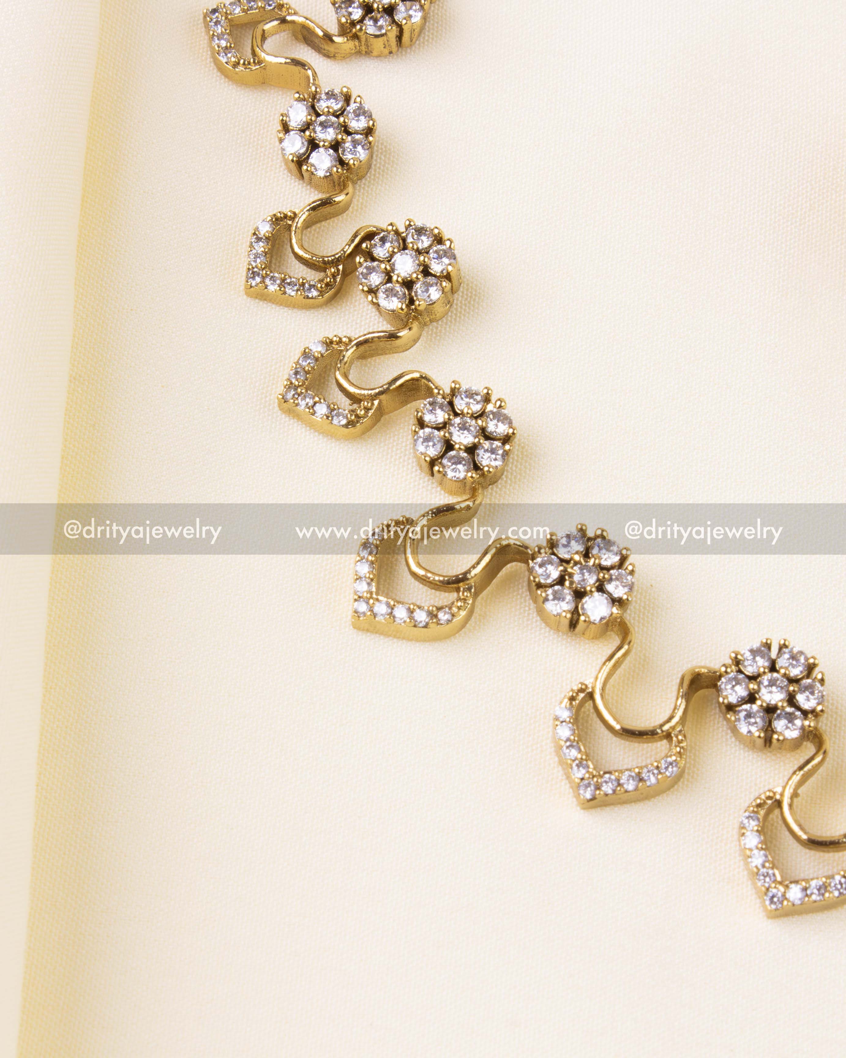 Detailed floral motifs and chevron stone pattern in gold finish