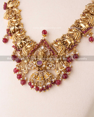 Ganesha temple pendant decorated with CZ stones and ruby-red beads.